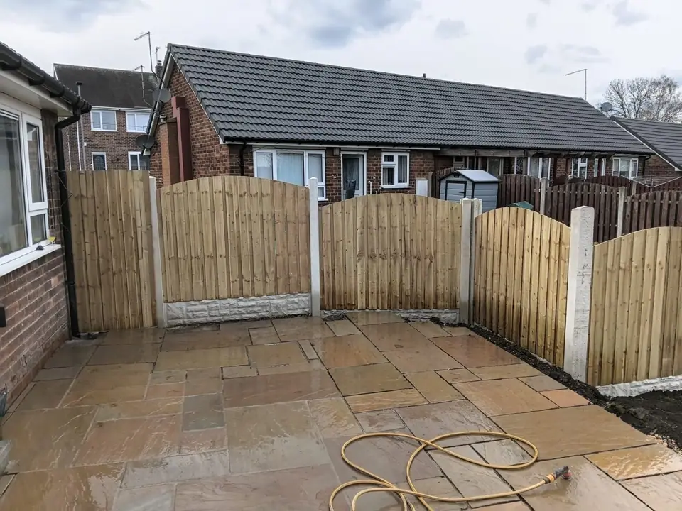 Completed stone patio with timber fencing on concrete posts and gravel boards