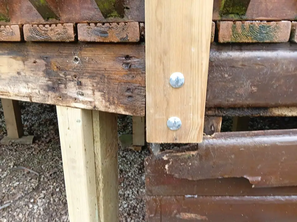 Timber post bolted through a deck bearer