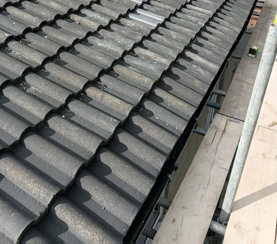 Roof tiles reinstated above the gutter after repair