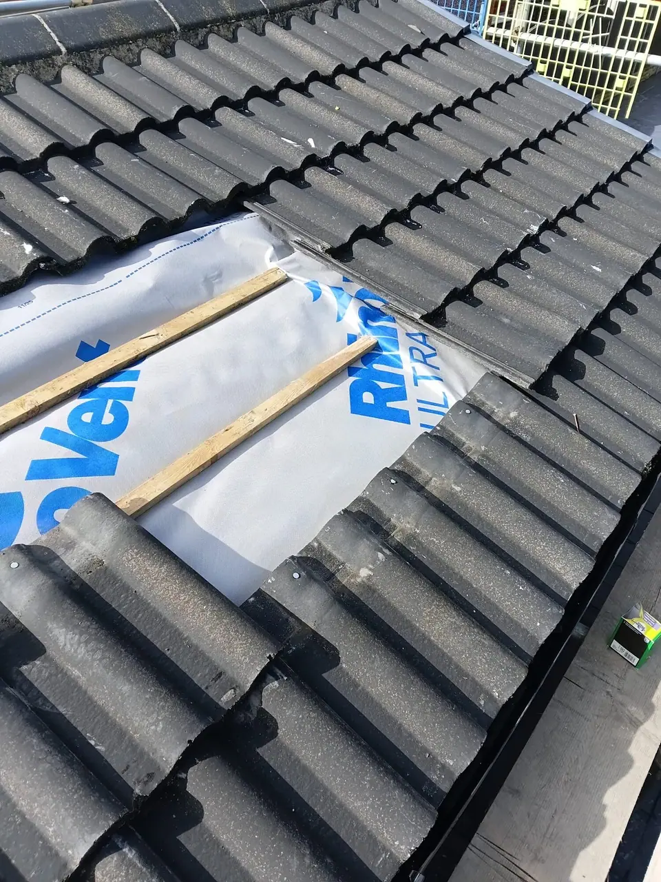 Roof repair showing the membrane and timber battens underneath the tiles